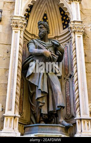 View at statue of St. Luke by Giambologna, at Orsanmichele church exterior in Florence, Italy Stock Photo