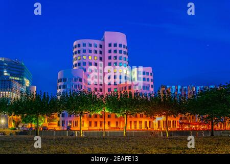 Night view of a modern building at Neuer Zollhof district in Dusseldorf, Germany Stock Photo