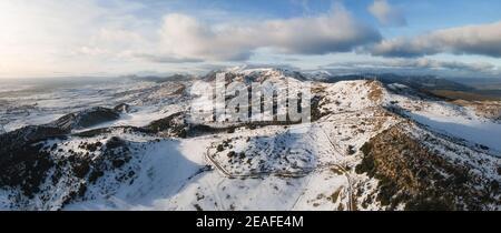 Aerial panoramic view over snow covered high mountains. High quality photo. Stock Photo