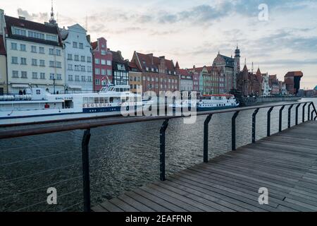 Gdansk, Poland - 05.06.2017: Cityscape of a Baltic sea port viewed from wooden walk by the canal. Traditional colorful houses in Gdansk, Poland. Stock Photo