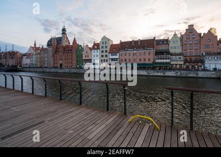 Gdansk, Poland - 05.06.2017: Cityscape of a Baltic sea port viewed from wooden walk by the canal. Traditional colorful houses in Gdansk, Poland. Stock Photo