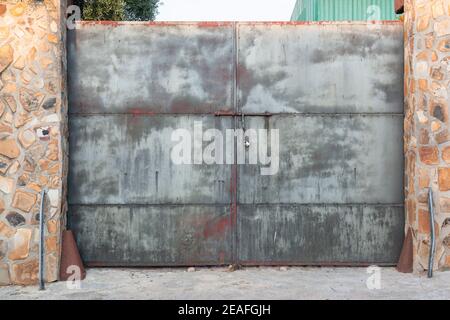 Old door of an abandoned factory in southern Spain, with a nice patina Stock Photo