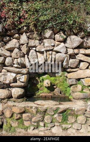 Old Drinking Water Fountain on wall Stock Photo