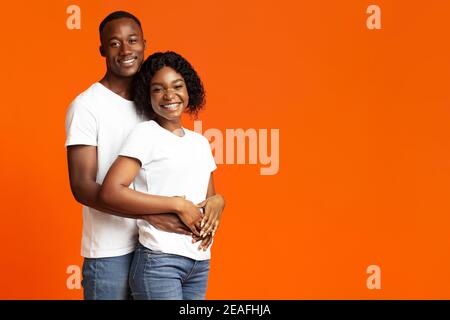 Happy african american couple bonding and smiling at camera Stock Photo
