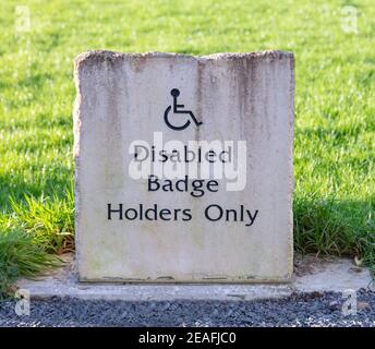 Stone Disabled Badge Holders Only parking sign Stock Photo