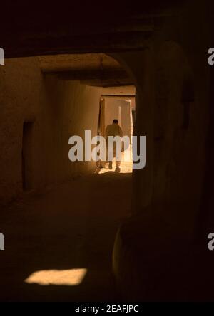 One man walking in the roofed streets, Tripolitania, Ghadames, Libya Stock Photo