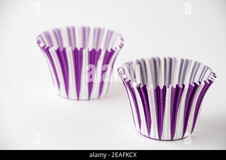 Top view of two striped paper muffin cups, selective focus, on white background, horizontal Stock Photo