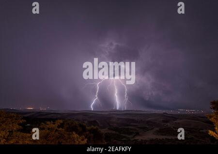 Beautiful night sky with lightning and thunderbolts during a thunderstorm in the countryside Stock Photo