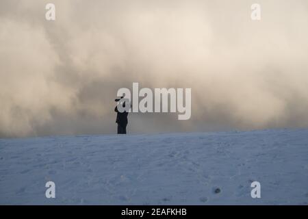 A person taking pictures after a snowstorm Stock Photo