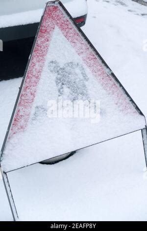 A roadwork sign covered in snow Stock Photo