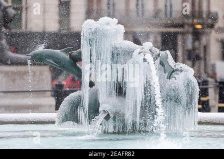 London, UK.  9 February 2021. UK Weather:  An ice covered frozen fountain in Trafalgar Square during light snow flurries as the cold weather brought on by Storm Darcy continues. Credit: Stephen Chung / Alamy Live News Stock Photo