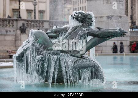 London, UK.  9 February 2021. UK Weather:  An ice covered frozen fountain in Trafalgar Square during light snow flurries as the cold weather brought on by Storm Darcy continues. Credit: Stephen Chung / Alamy Live News Stock Photo