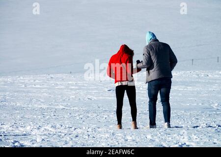 Man woman walking winter holding hands woman walking snow Stock Photo