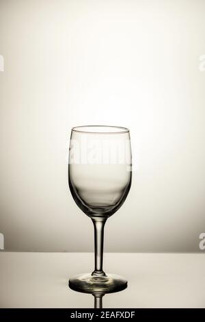 Empty wine glass with reflection isolated on white background. Glass dishware. Stock Photo
