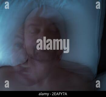 Man having a nightmare, scary ghosting. Motion blur. Stock Photo
