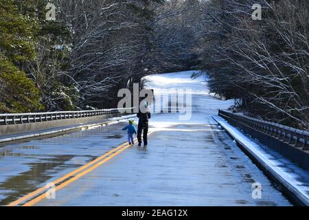 A mother walks with her child along a section of the Blue Ridge Parkway that is closed to cars for the winter near Asheville, North Carolina Stock Photo