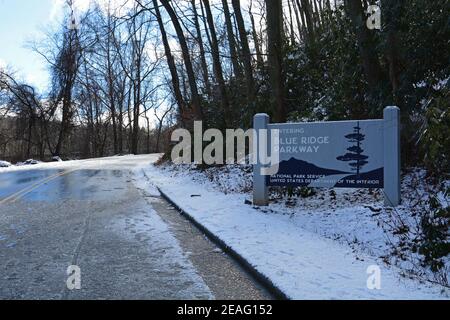 Ice and snow coats the road on a section of the Blue Ridge Parkway closed to cars for the winter near Asheville, North Carolina Stock Photo