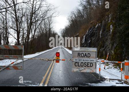 Barricades prevent vehicle access to a section of the Blue Ridge Parkway that is closed for the winter near Asheville, North Carolina Stock Photo
