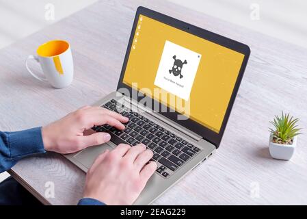 Hacked laptop computer with pop-up message on desktop concept. Man work on computer Stock Photo