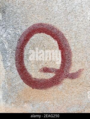 Red graffiti of a letter Q Stock Photo