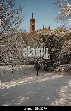 University of Glasgow tower from Kelvingrove Park after heavy snow in Glasgow. February 2021 Stock Photo
