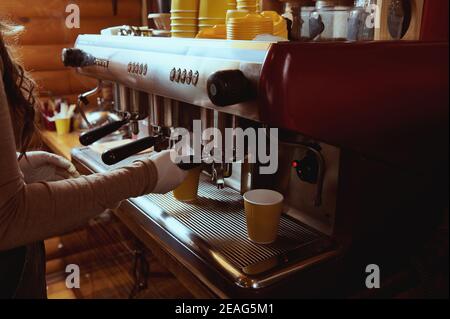 Closeup of barista making coffee in professional coffee machine Stock Photo
