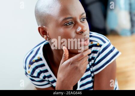 Ethnic Student girl sat on the floor studying Stock Photo