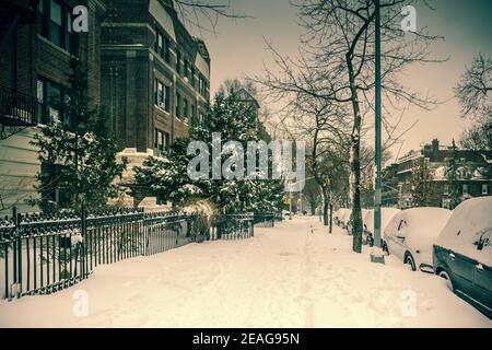 Snowy winter scene with buildings along 12th Street during a