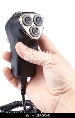Electric razor in hand isolated on white background. Stock Photo