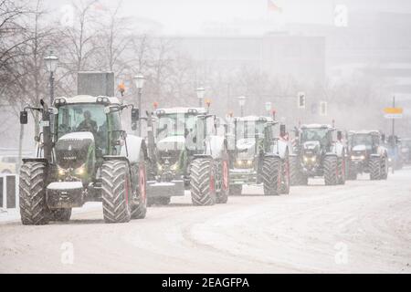 Berlin, Germany. 8th Feb, 2021. Farmers and Agriculture workers drive in convoy with tractors during heavy snowfall through the government district in Berlin protesting against the German governments agriculture policies. Credit: Jan Scheunert/ZUMA Wire/Alamy Live News Stock Photo