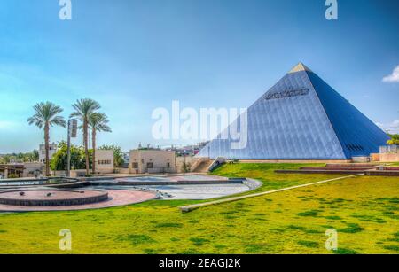 Musical fountain and a blue pyramide at gan binyamin park in Eilat, Israel Stock Photo