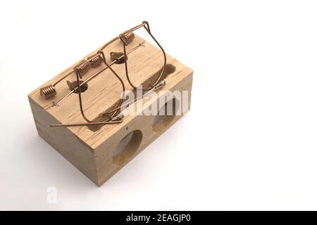 An empty wooden mousetrap to capture two mice (ratus ratus) on white background and copy space Stock Photo