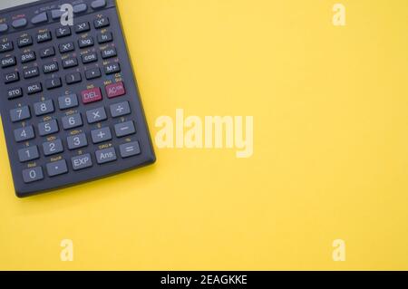 Top view of scientific calculator isolated on yellow background Stock Photo