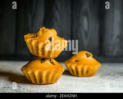 Delicious chocolate mini cake covered with glaze with additions of chocolate and tangerine Stock Photo
