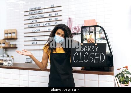 Sad African American waitress, barista or small business owner