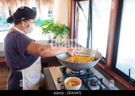 Face Mask Two Asian Female Cooks on Duty Chopping Vegetables Bright Philippine Kitchen Wearing Face Mask and Hair Net Close up Stock Photo