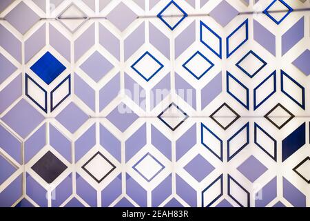 Photo of the surface of a luminous wall with three-dimensional shapes of triangles, lines and squares. Abstract design background. Stock Photo