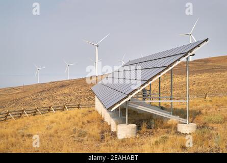 Wind Turbines and Solar Panel. Wind turbines and solar panels on an arrid field of grass in Washington State. Stock Photo