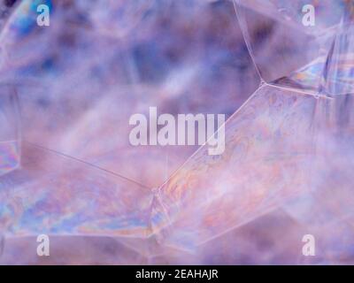 Macro view of transparent liquid bubbles with iridescent reflections on ...