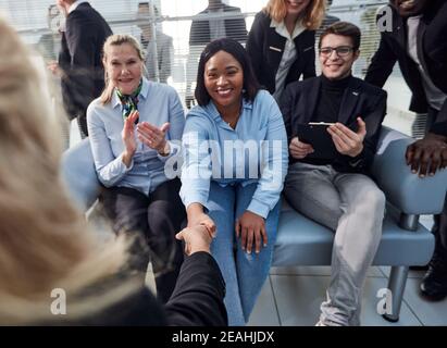 Great job. Successful business team is clapping their hands in modern workstation, celebrating the performance of new product Stock Photo