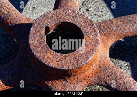 Flaky brown rust on a rusty wheel hub Stock Photo