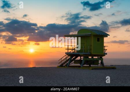 Beautiful sunrise at tropical Miami beach and life guard tower, South Miami Beach, Florida. Stock Photo