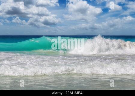 Beautiful sea waves with foam of blue and turquoise color in tropical ocean Stock Photo