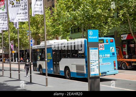 Sydney bus travels along York street in the Sydney city centre past the Wynyard bus stop ,Sydney,NSW,Australia Stock Photo