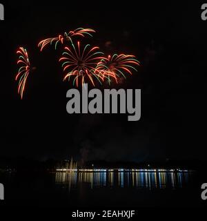 Colorful fireworks with reflection lights on lake Stock Photo