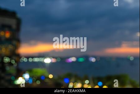 Bokeh lights and blur city skyline sunset of sea bay background. Stock Photo
