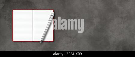 Red open lined notebook with a pen isolated on dark concrete background. Horizontal banner Stock Photo