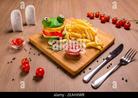 Crazy frog burger on a wooden board. Stock Photo
