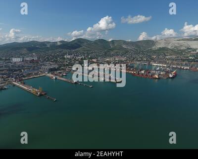 Industrial seaport, top view. Port cranes and cargo ships and barges. Stock Photo