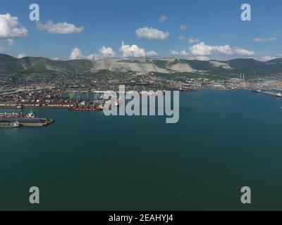 Industrial seaport, top view. Port cranes and cargo ships and barges. Stock Photo